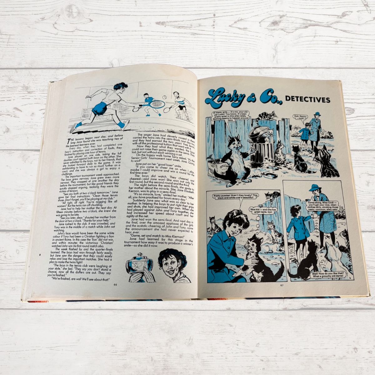 Open book with comic strip titled 'Lucky & Co. Detectives' on a wooden surface