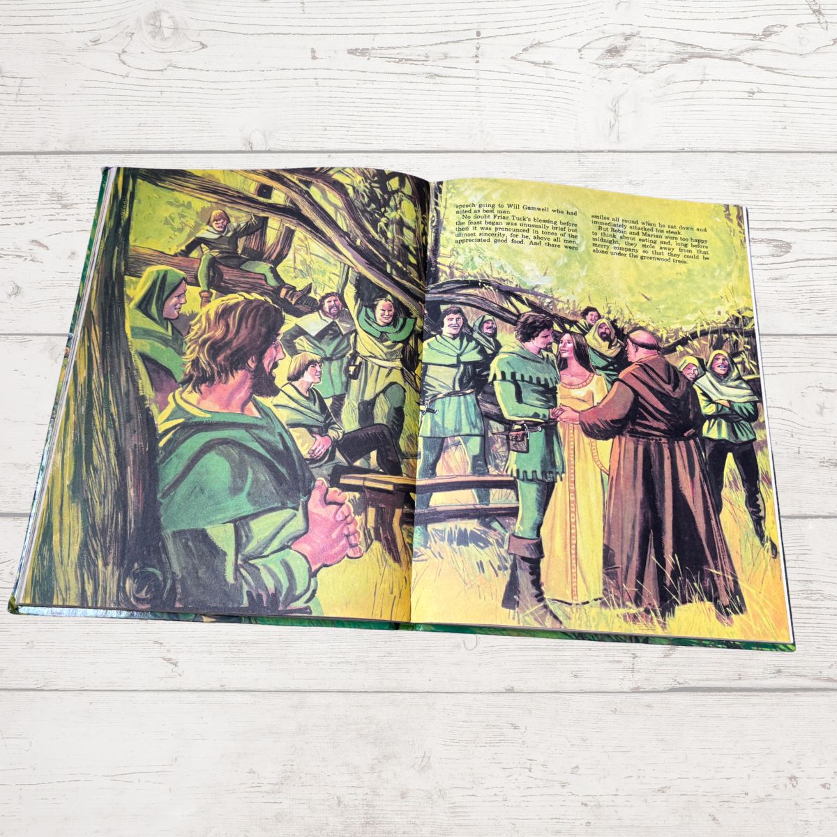 Open book with illustrated pages on a wooden surface