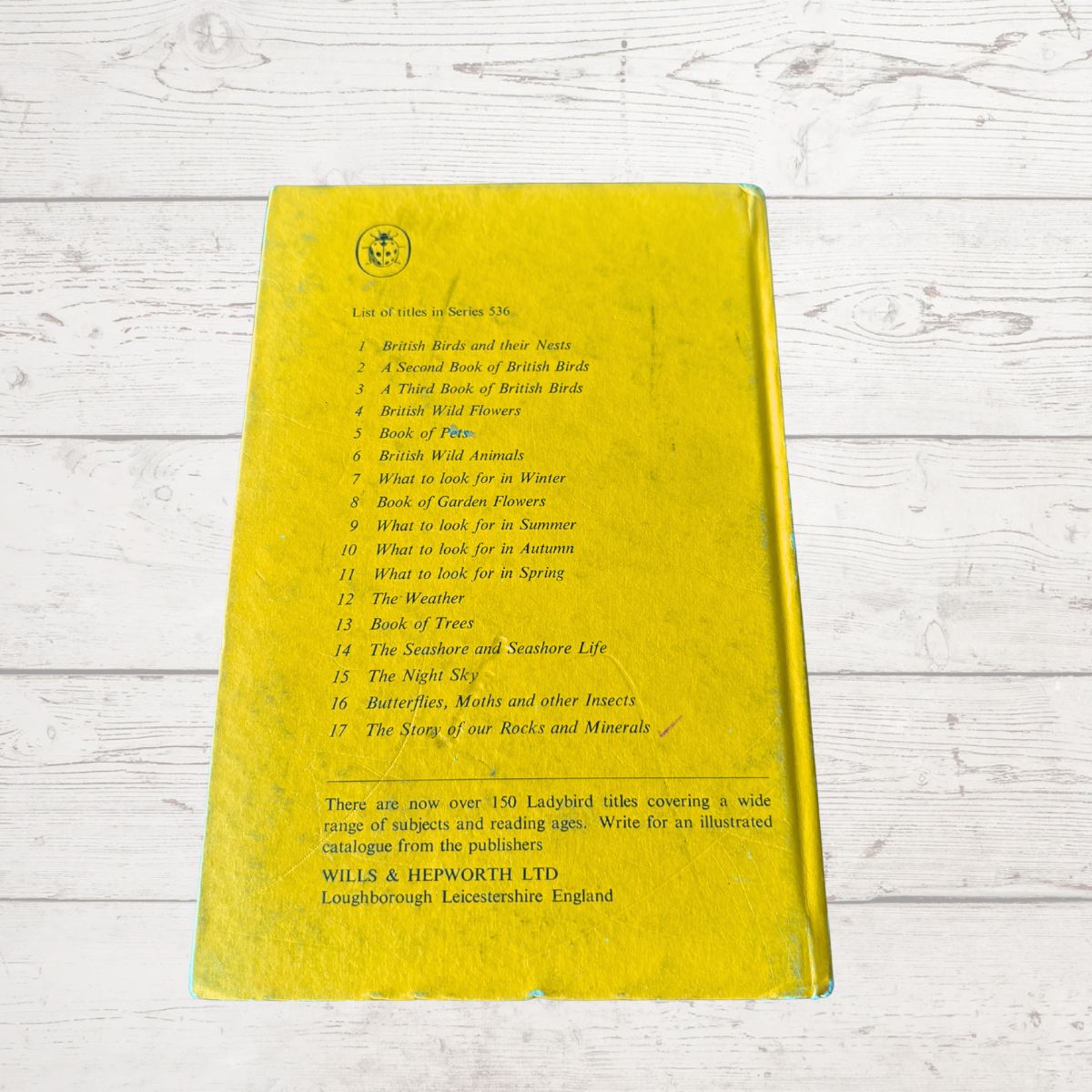 Yellow book with text on a wooden surface
