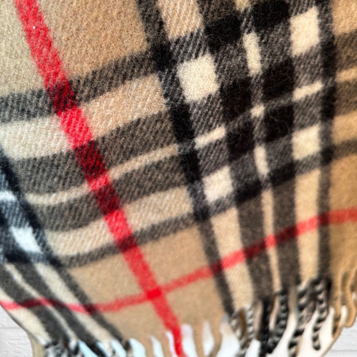 Close-up of a checkered fabric with red, black, and beige colors.