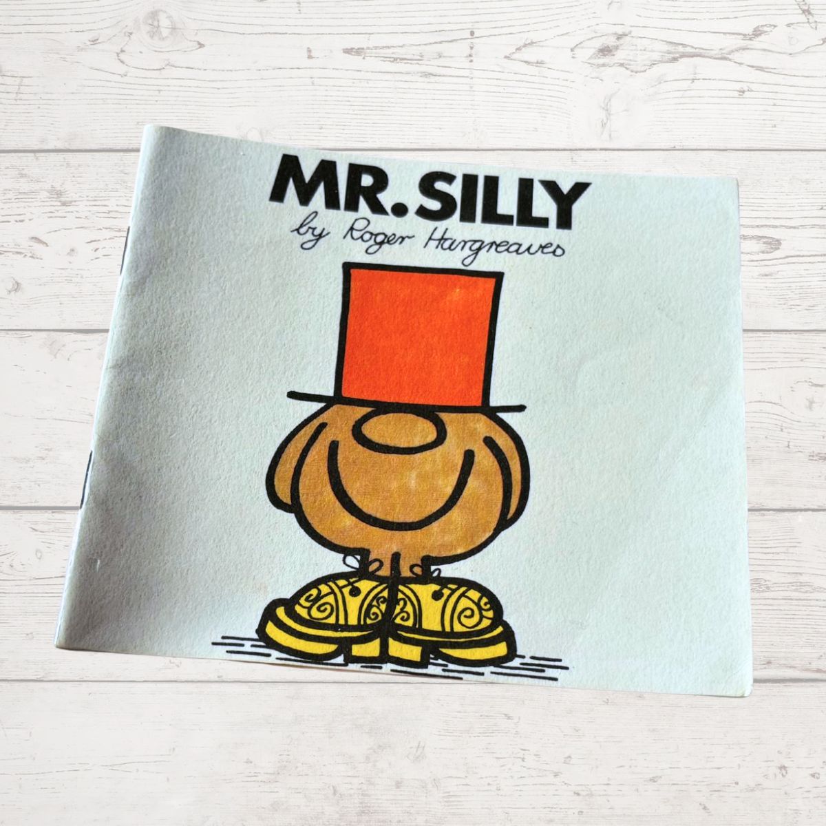 Book titled 'Mr. Silly' by Roger Hargreaves on a light wooden surface