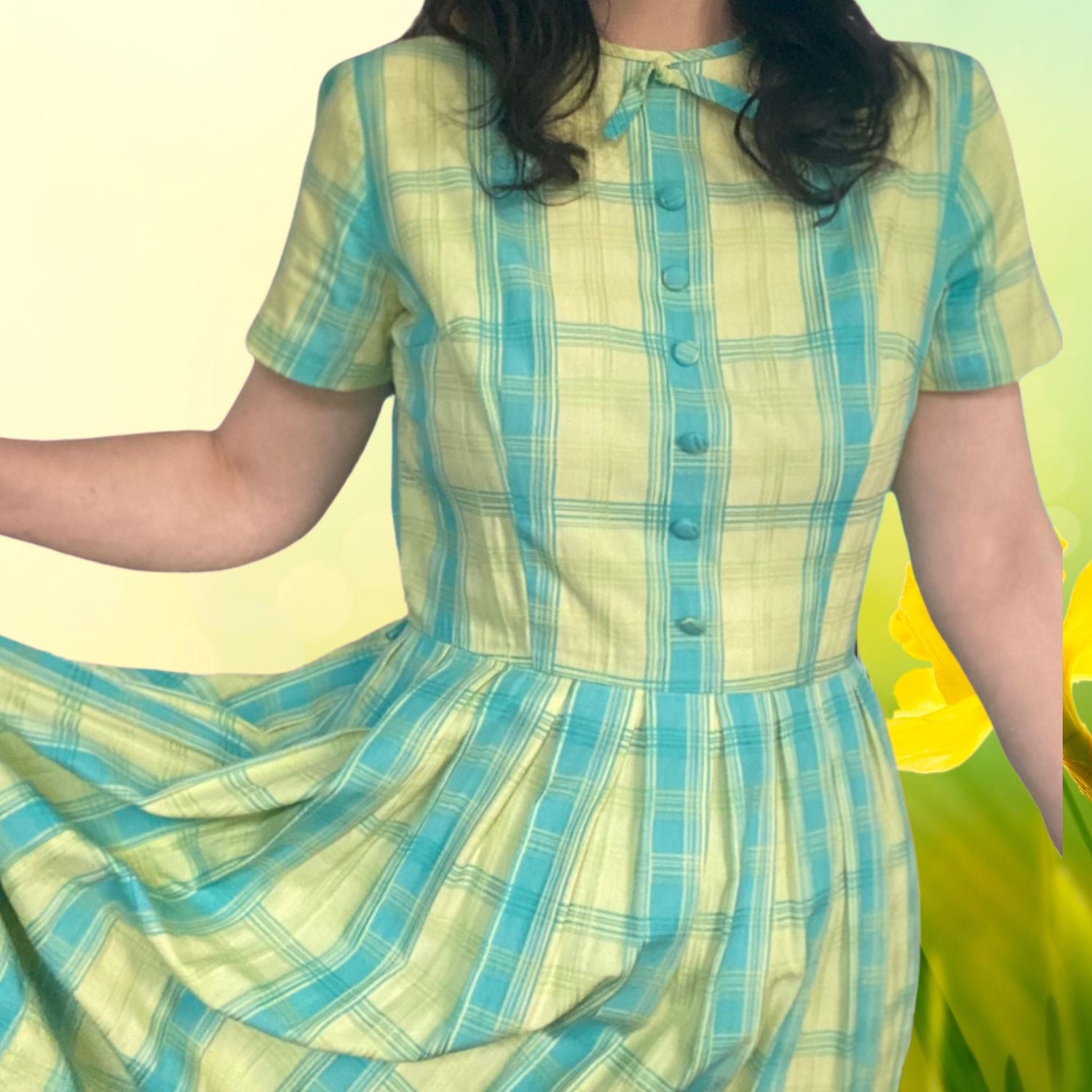 A lilac and white cotton gingham 1950s dress with short sleeves and a mauve bow at the waist