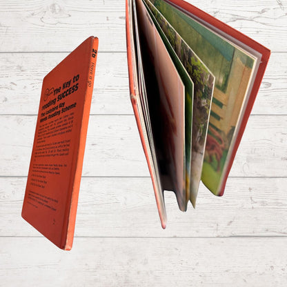 Open book with colorful pages on a white wooden surface