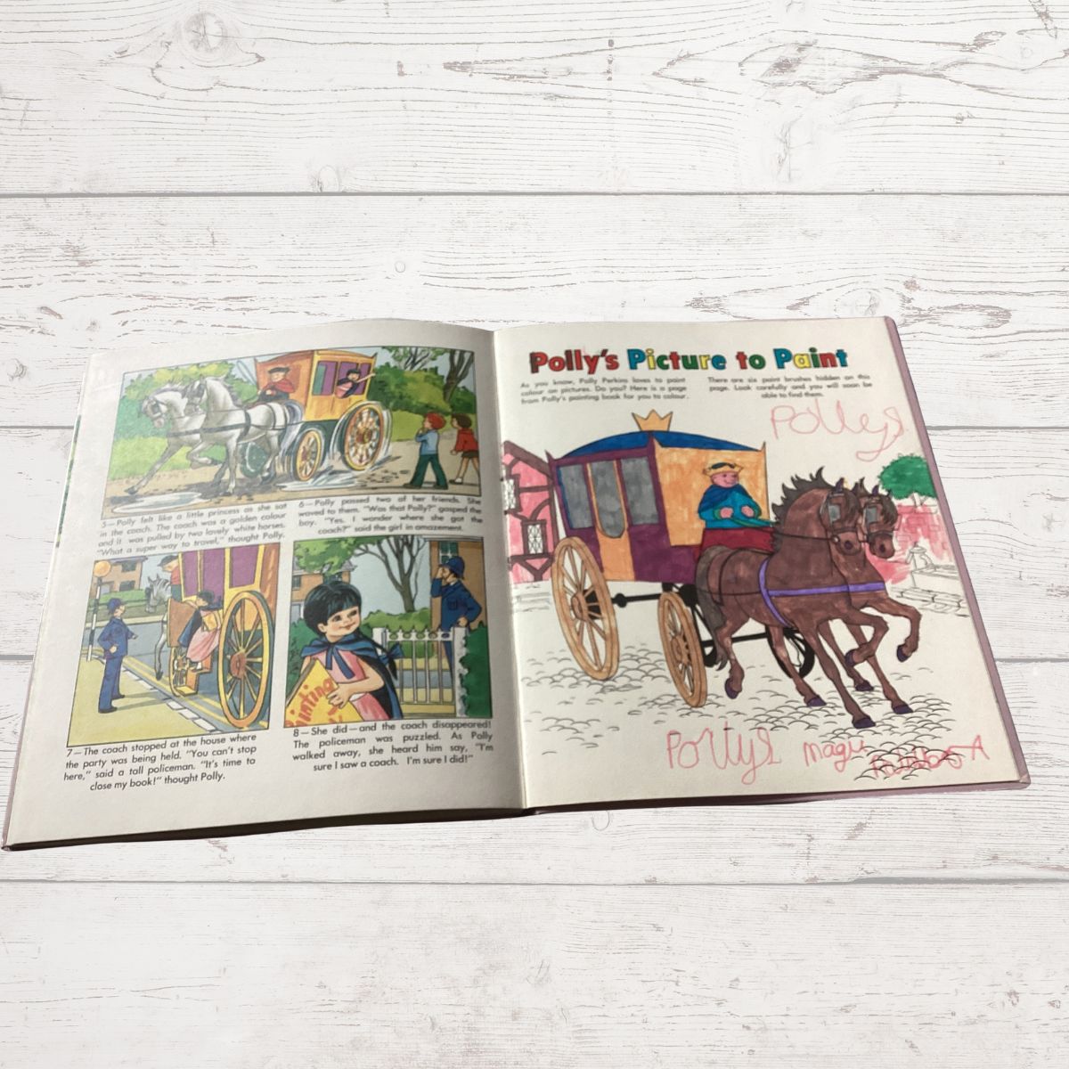An open vintage children's book  spread laid flat on a white wooden surface. The right page has a comic-style illustration titled 'Polly's Picture to Paint' showing a horse-drawn carriage, and the left page contains four small illustrated panels with text.