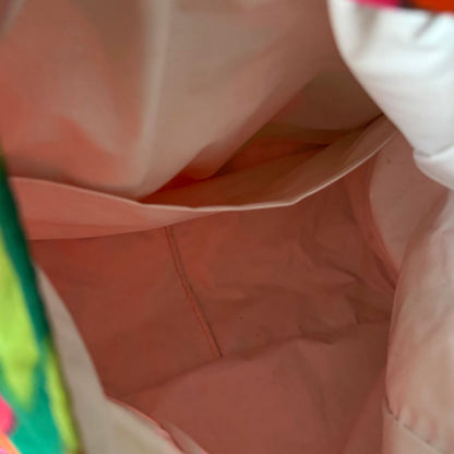 Close-up view of the inside of a plastic lined bag, showing fabric folds and a seam.