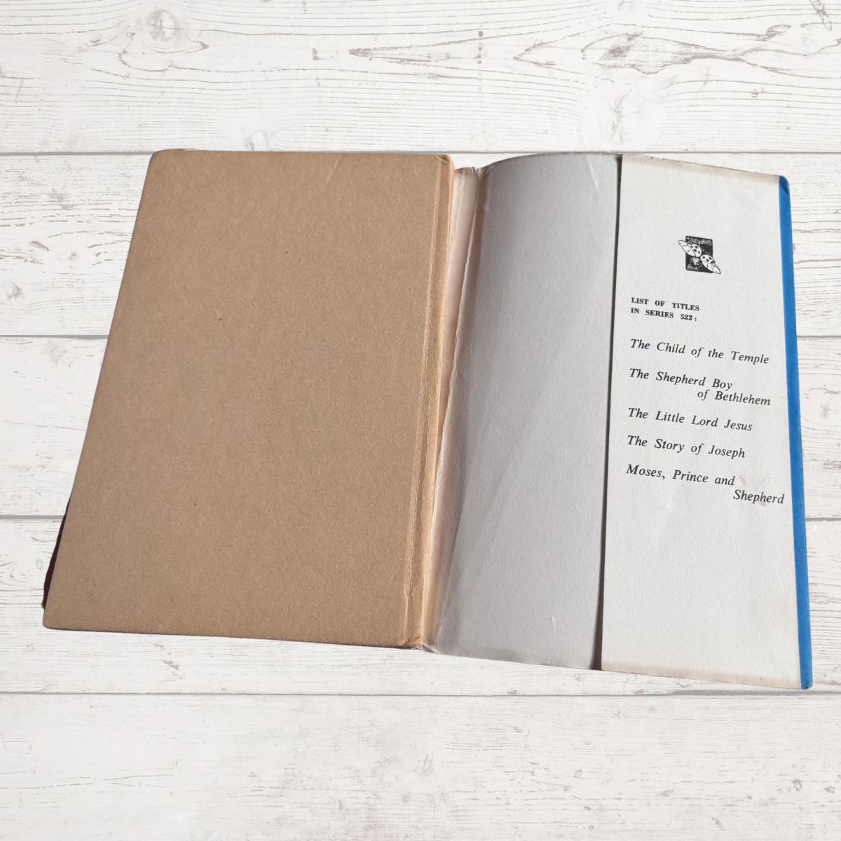 Open book with text on a wooden surface