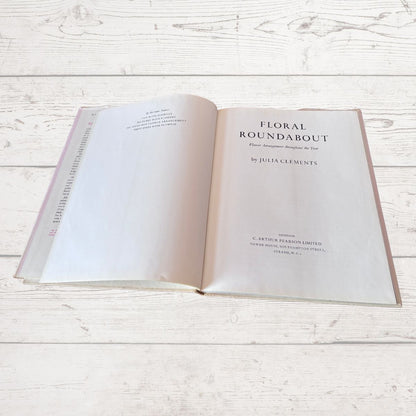 Open book titled 'Floral Roundabout' on a wooden surface