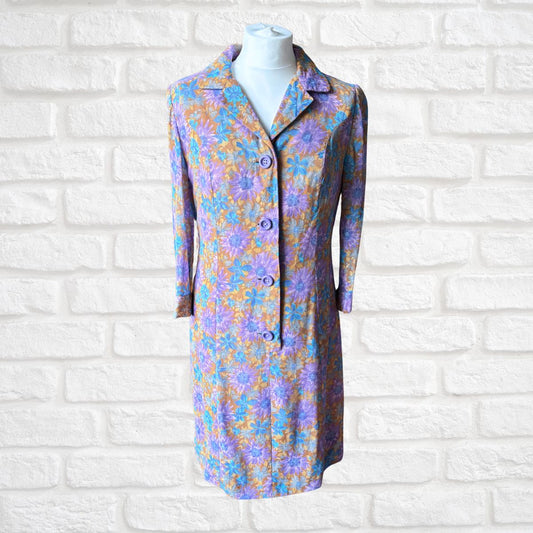 Floral patterned dress on a mannequin against a white brick wall background