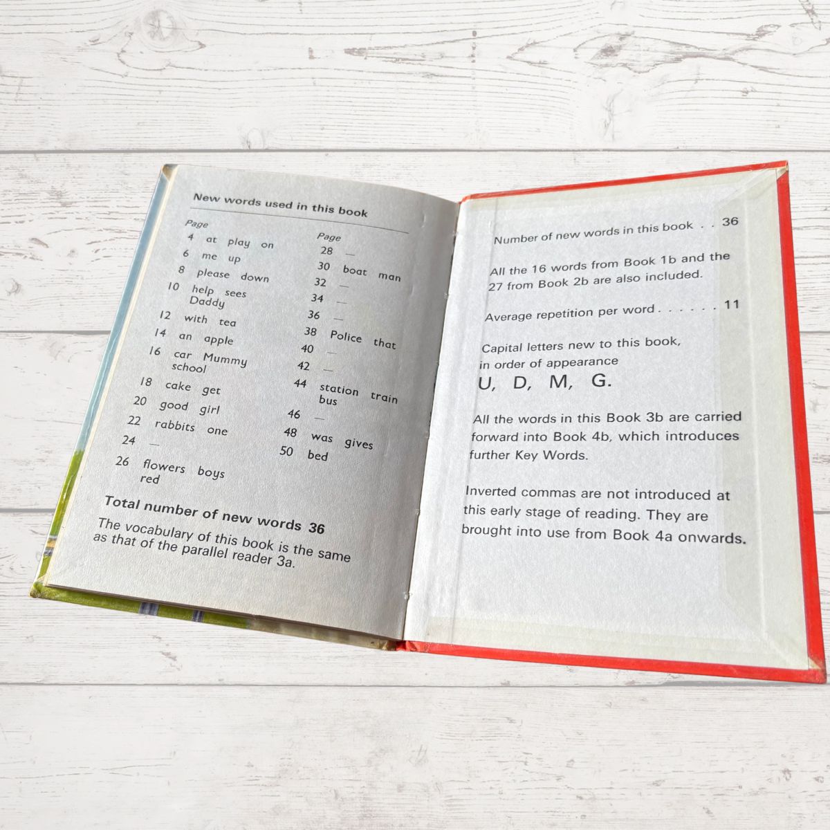Open book with text on a wooden surface