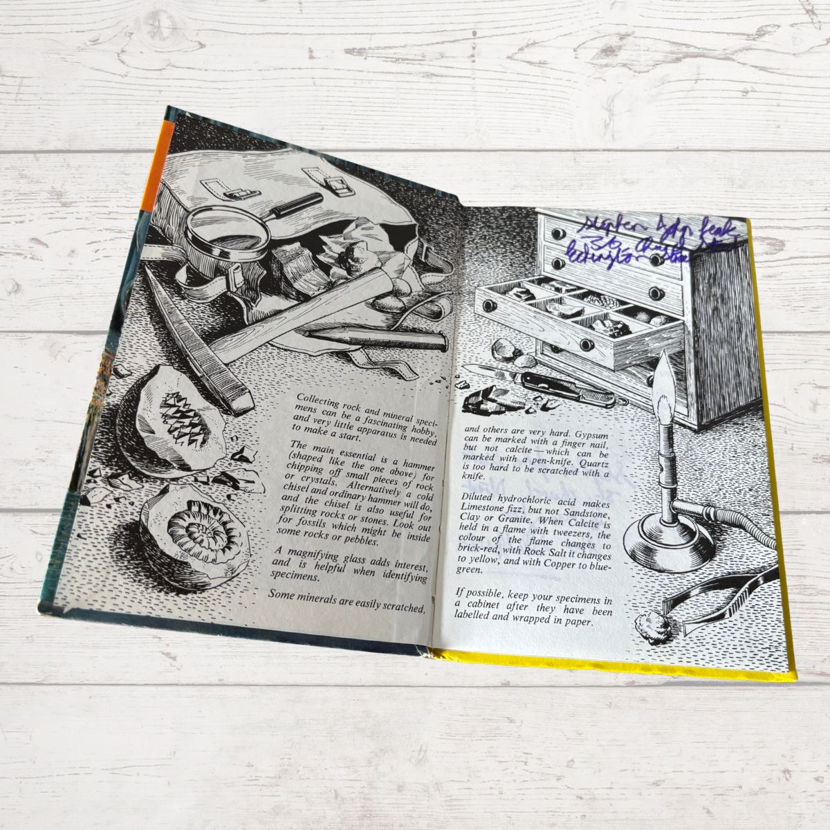Open book with illustrations of scientific equipment on a wooden surface