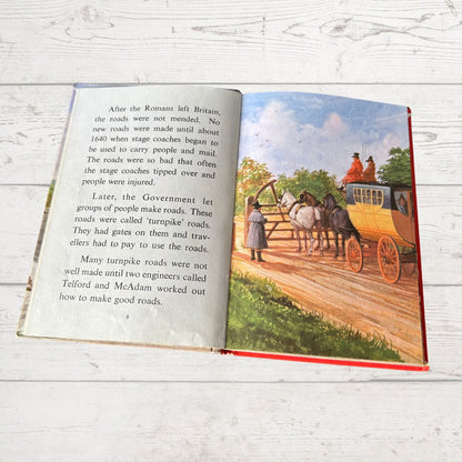 Open book with text and illustration of a stagecoach on a wooden floor
