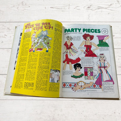 Open book with illustrated pages on a wooden surface