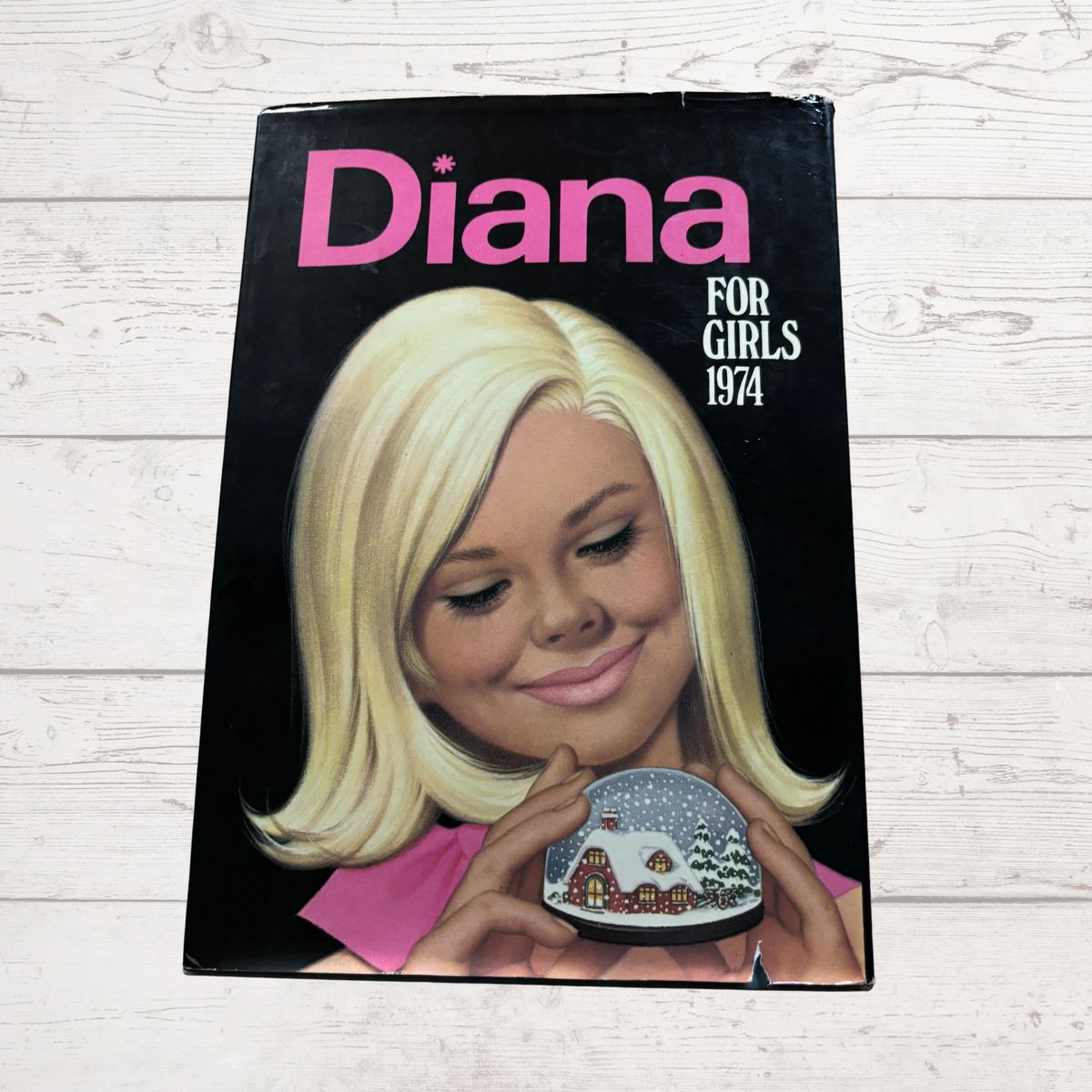 vintage Diana Annual 1974 on a white wood background 