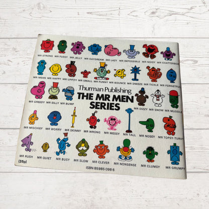 Vintage book cover of 'The Mr Men Series' by Thruman Publishing on a wooden surface.