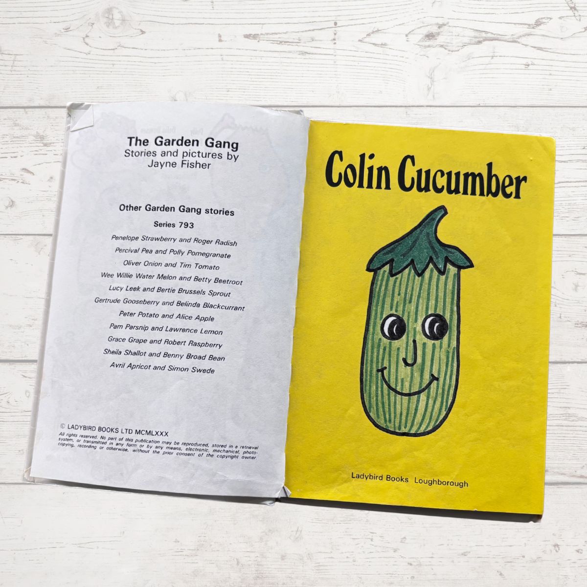 Open book showing the cover of 'Colin Cucumber' with a yellow background and cucumber illustration.