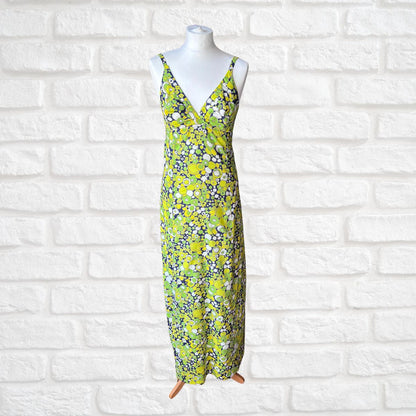 Abstract Floral dress on a mannequin against a white brick wall background