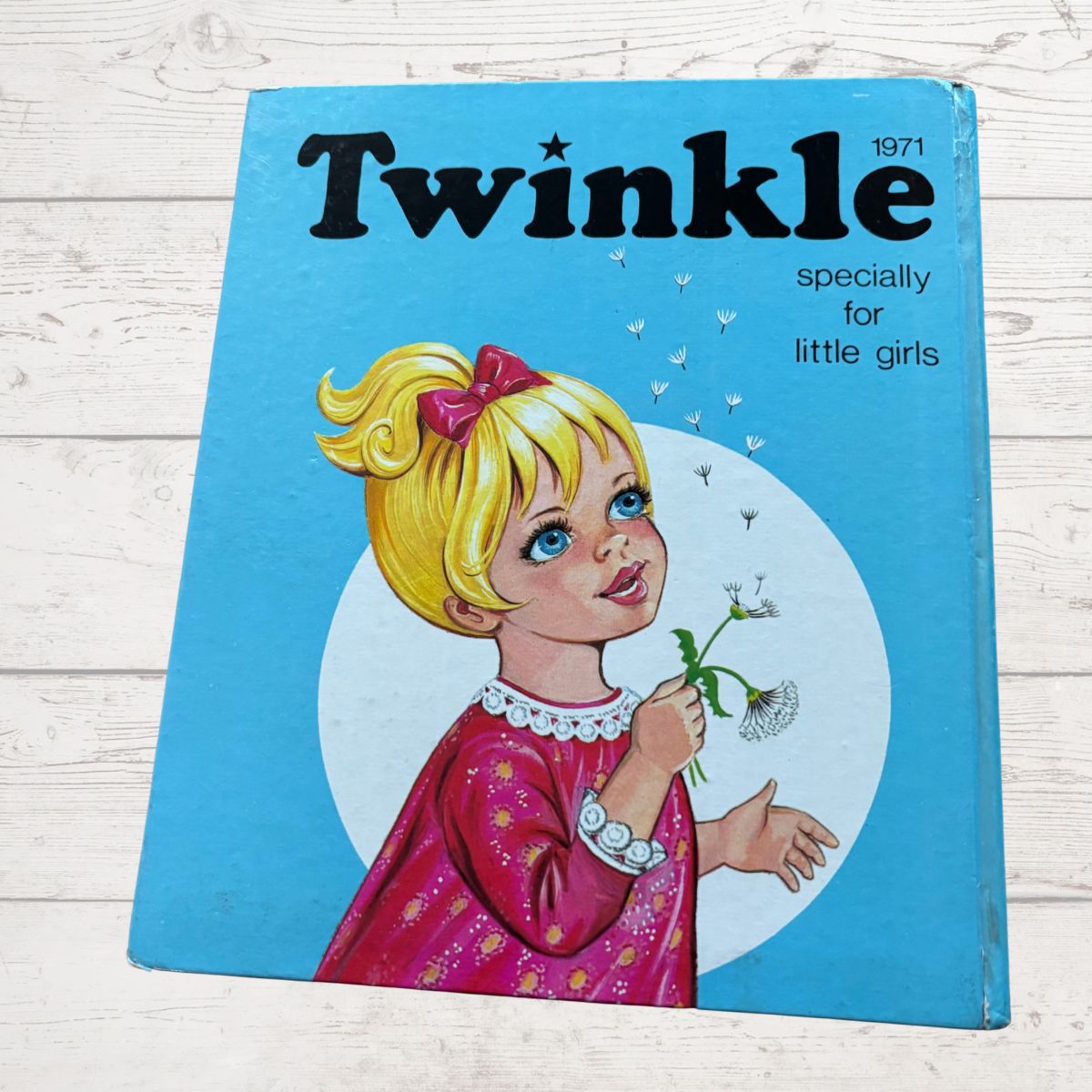 Vintage 'Twinkle' book for little girls from 1971 on a wooden surface