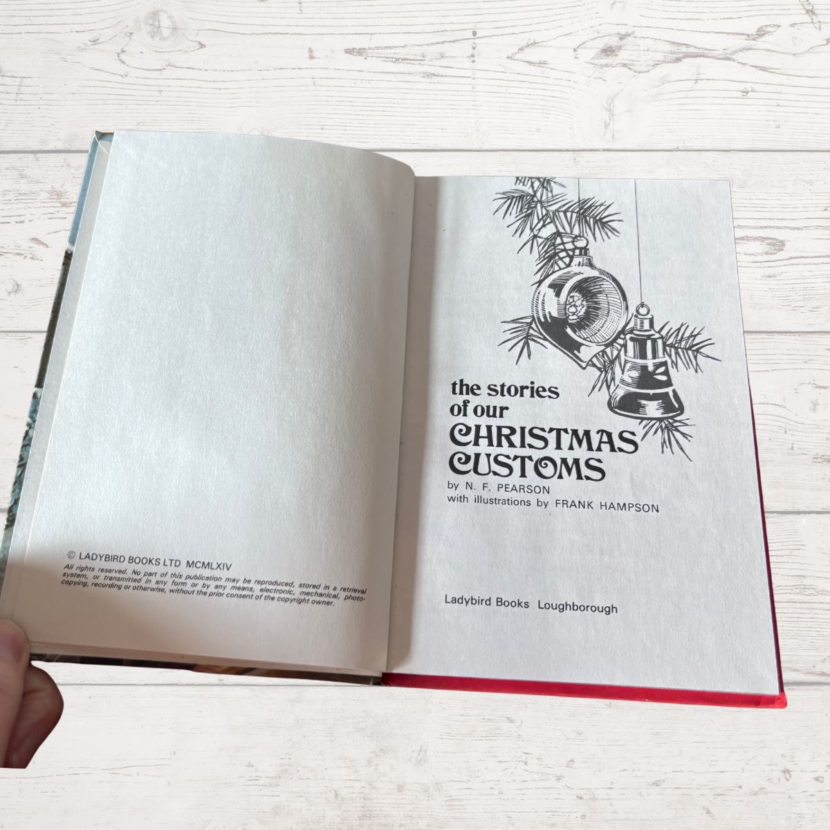 An open vintage hardcover book titled 'The Stories of Our Christmas Customs' b