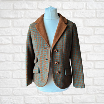 Checked blazer shown open  on a mannequin against a white brick wall background
