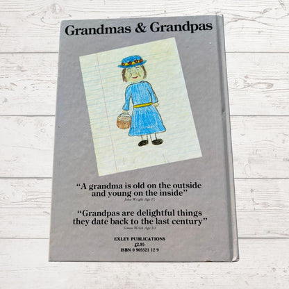Book titled 'Grandmas & Grandpas' with a drawing of a woman on the cover, on a wooden surface.