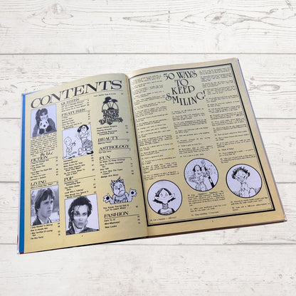 Open book with a vintage layout on a light wooden surface