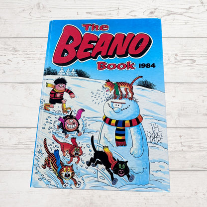 The Beano Book 1984 comic book cover featuring Beano characters, photographed flat on a white wood background.