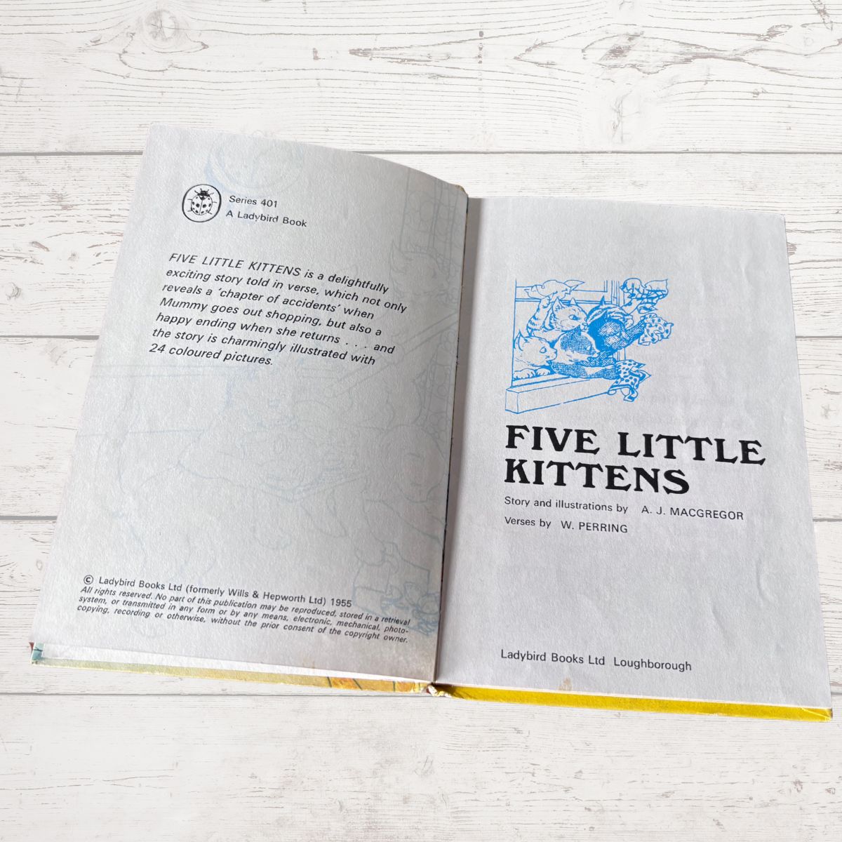 An open copy of the children's book 'Five Little Kittens' by A. J.