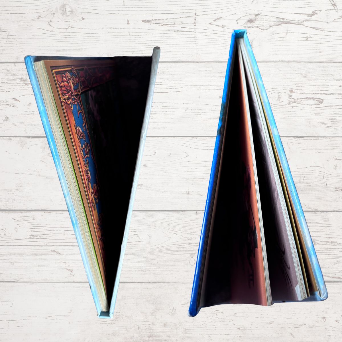 Book edges on a white wood plank background.