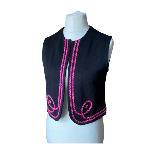 A stylish 70s black waistcoat with vibrant pink and purple embroidery and beaded flowers.