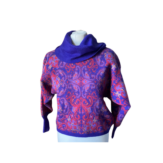 eye-catching long sleeved cropped jumper, featuring an abstract purple, red, and yellow pattern.