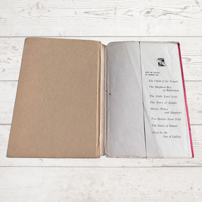 Open book with text on a light wooden surface