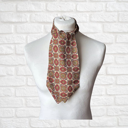 Patterned 60s cravat  on a mannequin against a white brick wall background