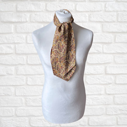 Patterned cravat  on a mannequin against a white brick wall background