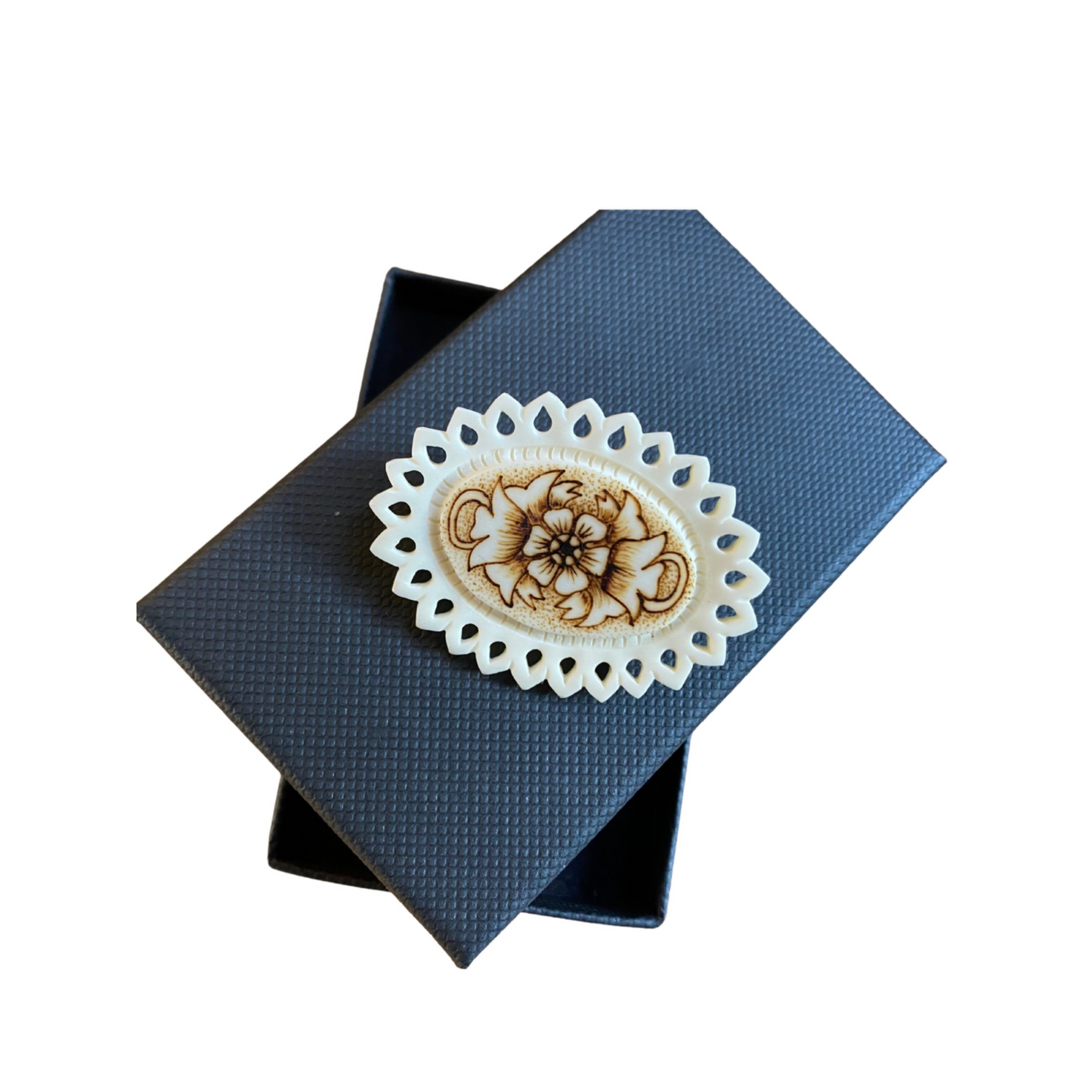 Gift-worthy cream brooch with intricate floral pattern