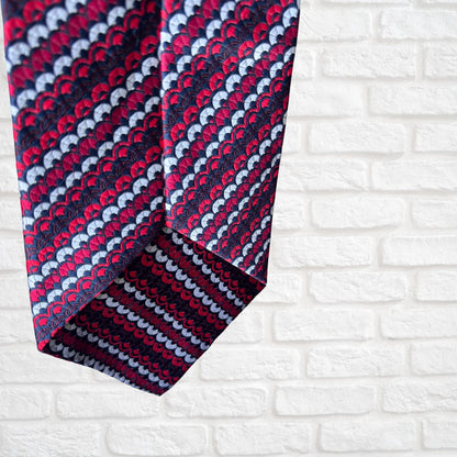 Patterned tie on a white brick wall background