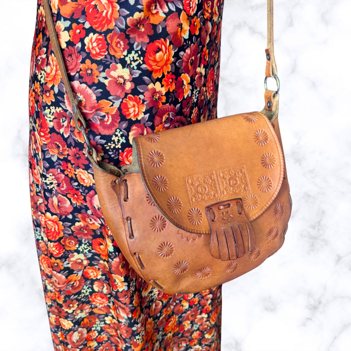 Brown leather h shoulder bag on a floral dress 