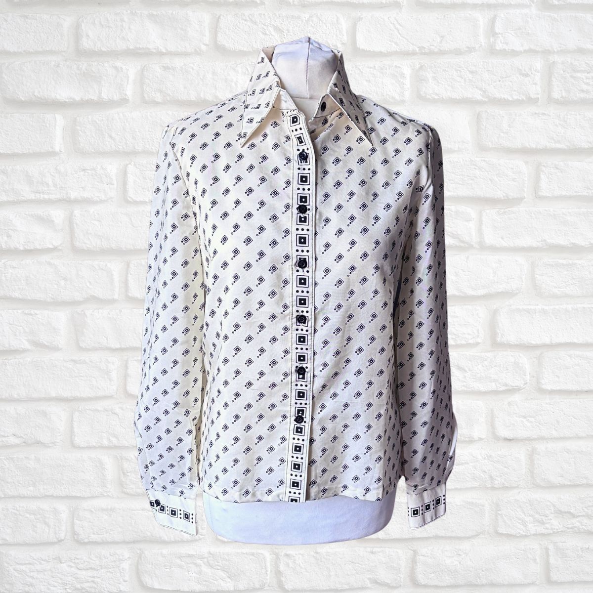 Cream and black geometric print 70s shirt with dagger collar on a white background 