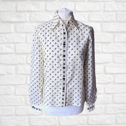 Cream and black geometric print 70s shirt with dagger collar on a white background 
