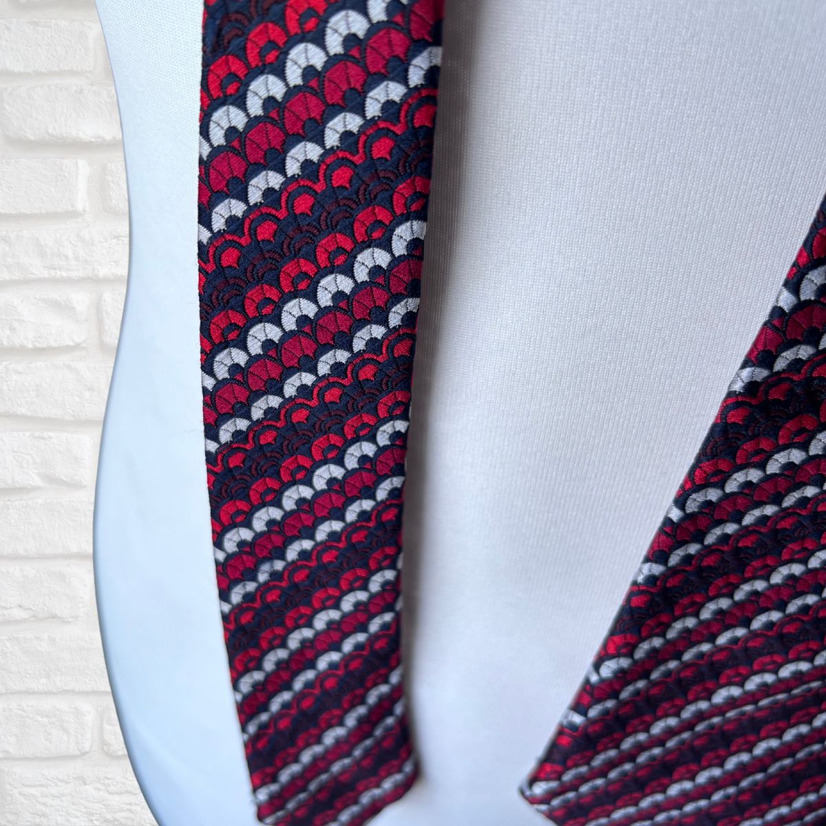 Patterned tie on a mannequin with a white background