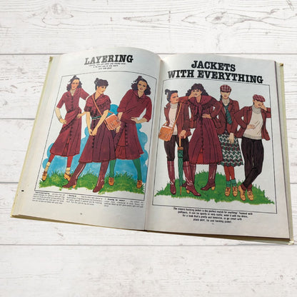 Open book showing illustrations of women wearing red jackets with text on a wooden surface