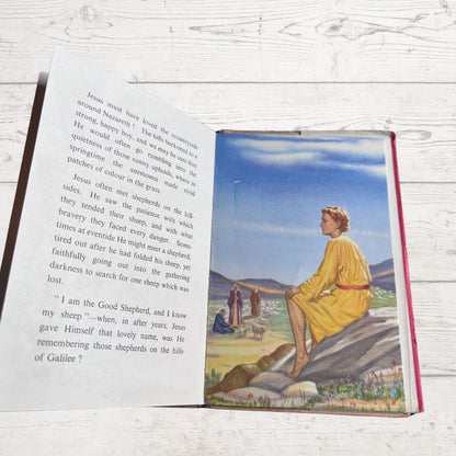 Open book with a colored illustration on a wooden surface