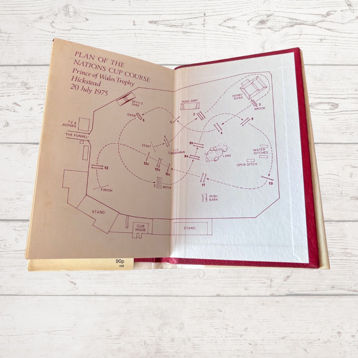 Open book with horse racing course plan 
