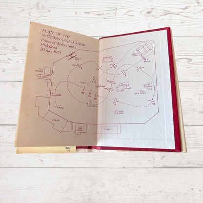 Open book with horse racing course plan 