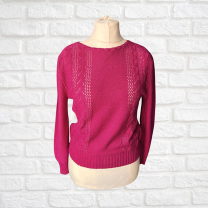 Pink sweater on a mannequin against a white brick wall background