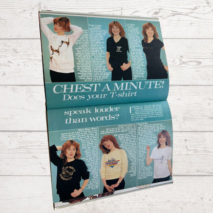 Vintage magazine advertisement with a woman wearing a t-shirt on a light wooden background