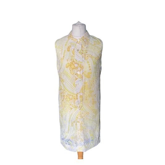 60s mini shift dress with dagger collar and button down front placket. Swirly floral design featuring various shades of yellow, white and transparent areas  where the yellow lining is visible 