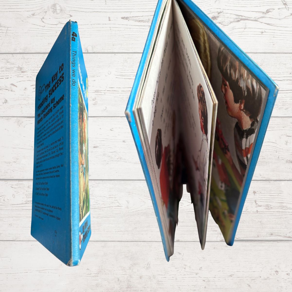Open book with colorful illustrations on a wooden surface