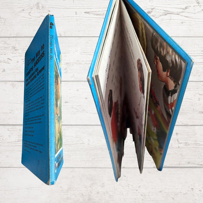 Open book with colorful illustrations on a wooden surface