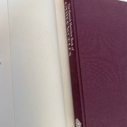A close-up of a hardcover book with a textured burgundy-purple cover and cream spine, showing the title 'The Hamilton Hamilton Book of QUEENSLAND' printed vertically.