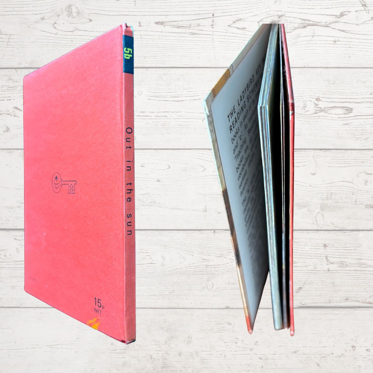 Red book with a key design on a light wooden surface